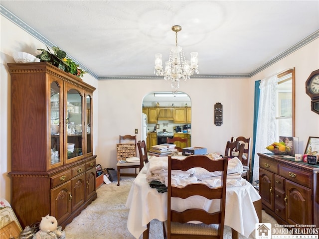 1501 Windfall Rd, Olean, NY 14760 - dining room with arched walkways, a chandelier, crown molding, and light colored carpet