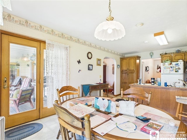 1501 Windfall Rd, Olean, NY 14760 - dining space with arched walkways, wallpapered walls, and light floors