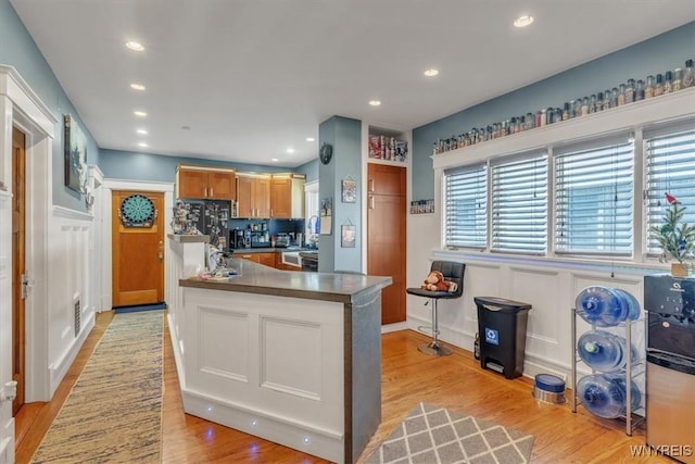 592 Parkside Ave, Buffalo, NY 14216 - kitchen with a decorative wall, light wood finished floors, dark countertops, a wainscoted wall, and recessed lighting