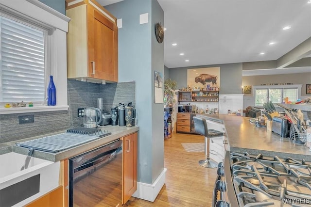 592 Parkside Ave, Buffalo, NY 14216 - kitchen with dishwasher, decorative backsplash, light wood-style flooring, recessed lighting, and brown cabinetry