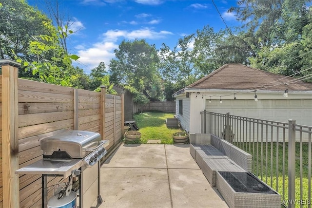 592 Parkside Ave, Buffalo, NY 14216 - fenced backyard featuring a patio, a grill, a garage, and an outbuilding