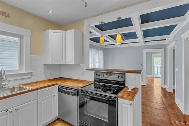 592 Parkside Ave, Buffalo, NY 14216 - kitchen featuring butcher block counters, electric range, stainless steel dishwasher, coffered ceiling, and backsplash