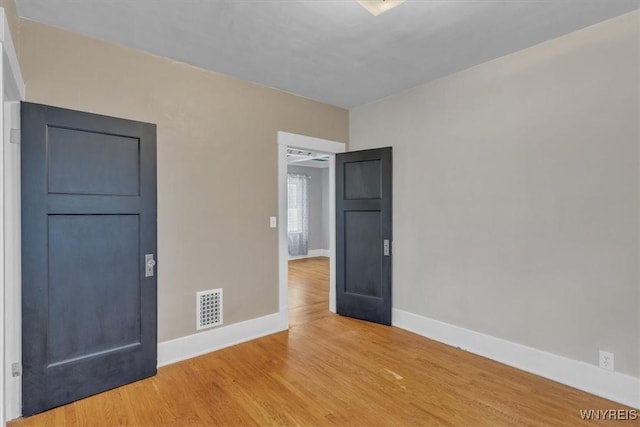 592 Parkside Ave, Buffalo, NY 14216 - unfurnished bedroom with baseboards and light wood finished floors