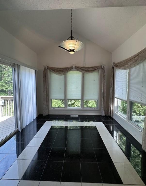 80 Endicar Dr, Irondequoit, NY 14622 - unfurnished dining area featuring vaulted ceiling and healthy amount of natural light