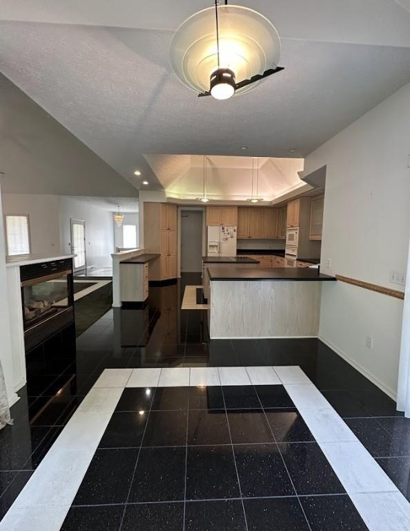 80 Endicar Dr, Irondequoit, NY 14622 - kitchen featuring granite floors, dark countertops, a peninsula, white fridge with ice dispenser, and recessed lighting