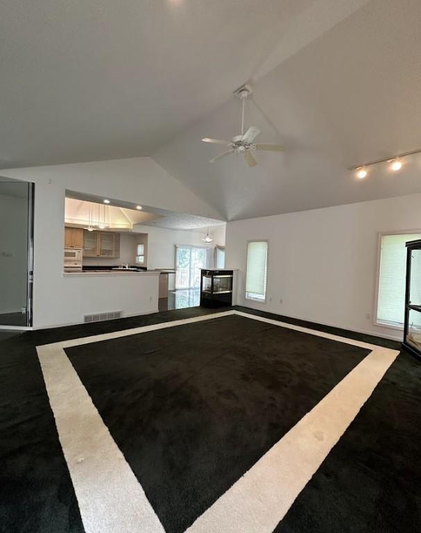 80 Endicar Dr, Irondequoit, NY 14622 - unfurnished living room with a ceiling fan, lofted ceiling, inlaid floor details, dark carpet, and recessed lighting