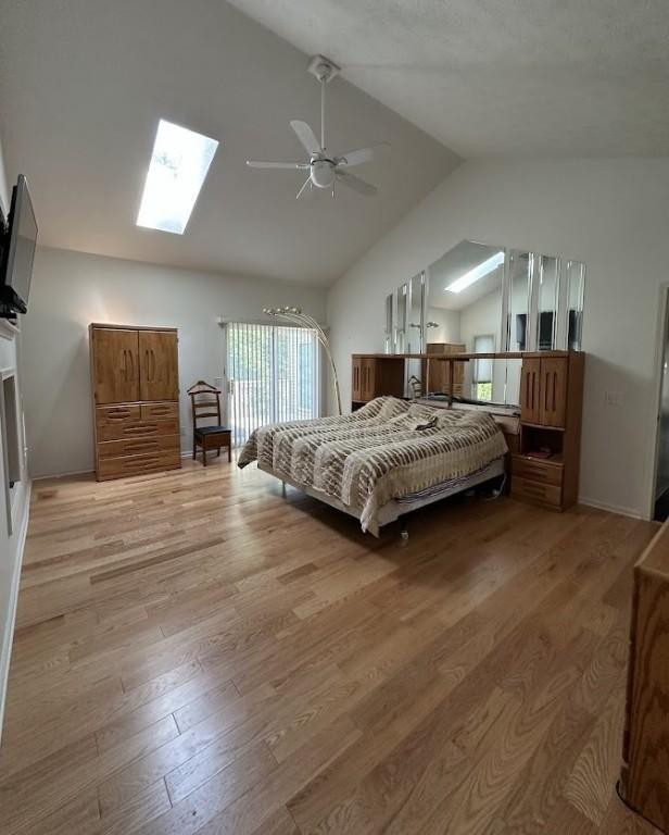 80 Endicar Dr, Irondequoit, NY 14622 - bedroom featuring lofted ceiling, a skylight, light wood-style floors, and ceiling fan