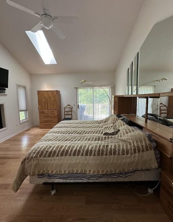 80 Endicar Dr, Irondequoit, NY 14622 - bedroom featuring vaulted ceiling, a skylight, wood finished floors, and a ceiling fan