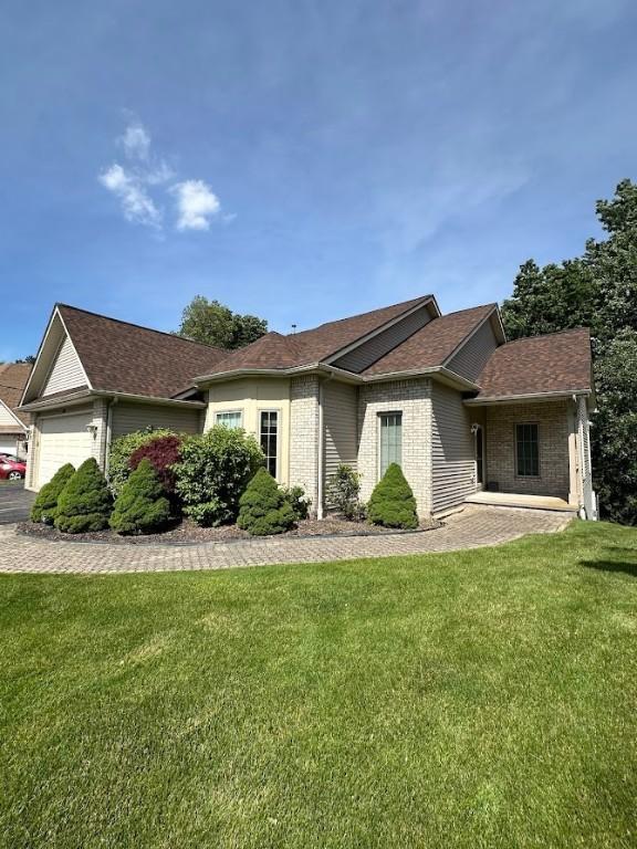 80 Endicar Dr, Irondequoit, NY 14622 - ranch-style house featuring a front yard, roof with shingles, an attached garage, and brick siding