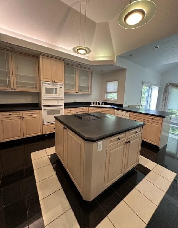 80 Endicar Dr, Irondequoit, NY 14622 - kitchen with white appliances, dark countertops, a center island, a peninsula, and glass insert cabinets