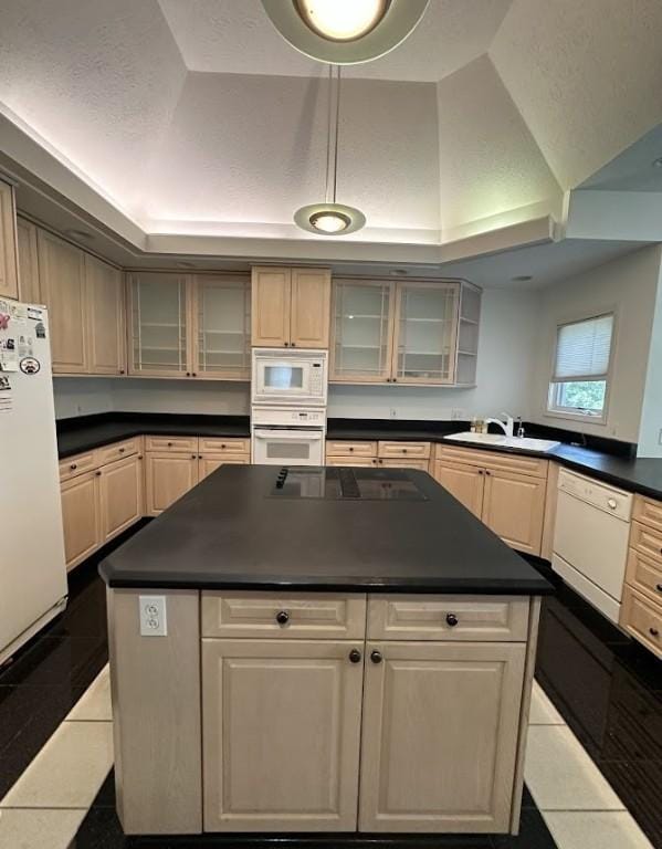 80 Endicar Dr, Irondequoit, NY 14622 - kitchen featuring white appliances, dark countertops, a kitchen island, tile patterned floors, and glass insert cabinets