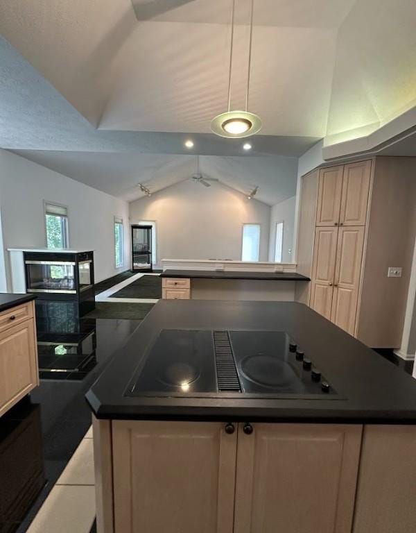 80 Endicar Dr, Irondequoit, NY 14622 - kitchen with lofted ceiling, dark countertops, black appliances, a kitchen island, and light tile patterned floors