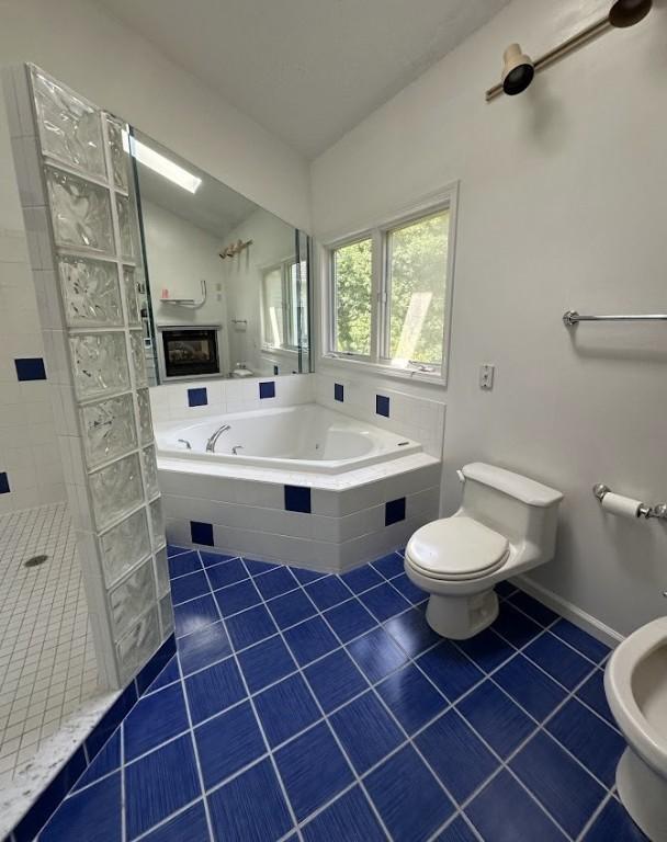 80 Endicar Dr, Irondequoit, NY 14622 - bathroom featuring tile patterned floors, a tub with jets, vaulted ceiling, and tiled shower