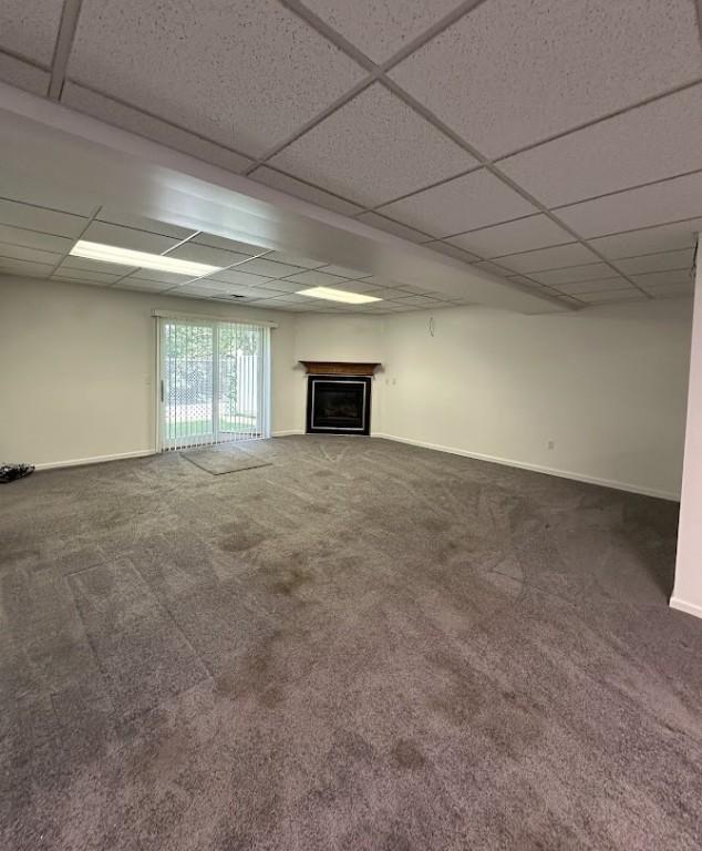 80 Endicar Dr, Irondequoit, NY 14622 - unfurnished living room with carpet floors, a fireplace, and a drop ceiling