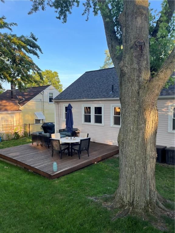 584 Falstaff Rd, Irondequoit, NY 14609 - rear view of property featuring a shingled roof, a yard, and a deck