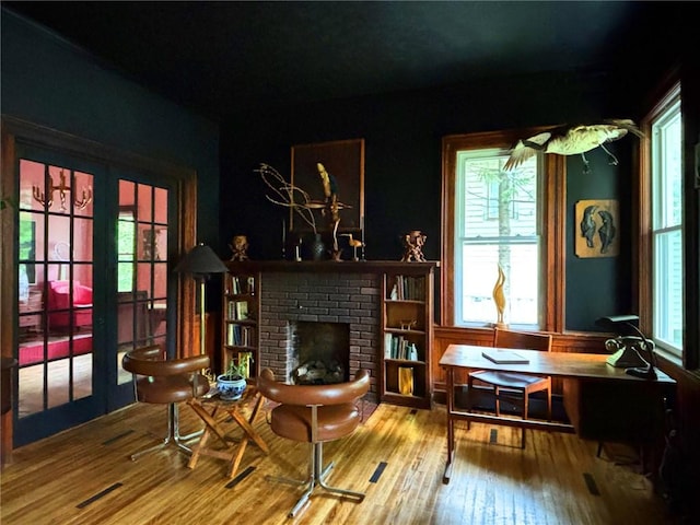 35799 State Highway 10, Hamden, NY 13782 - living area with hardwood / wood-style flooring, a brick fireplace, and french doors