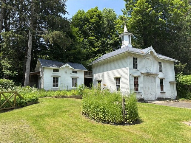 35799 State Highway 10, Hamden, NY 13782 - back of house with a lawn, an outbuilding, and a garage