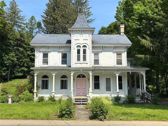 35799 State Highway 10, Hamden, NY 13782 - view of front facade with a porch, a chimney, and a front lawn