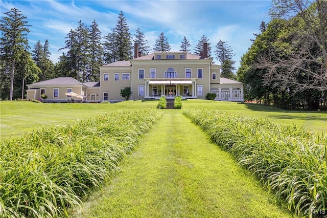 71 Forman St, Cazenovia, NY 13035 - view of front of home with a front yard, a chimney, and stucco siding