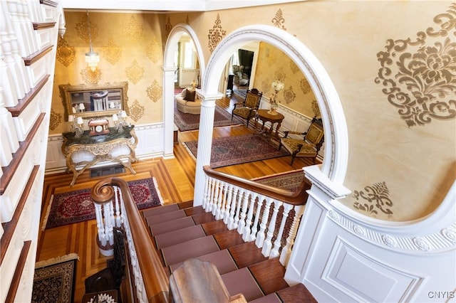 71 Forman St, Cazenovia, NY 13035 - stairway with wainscoting, wallpapered walls, and a decorative wall