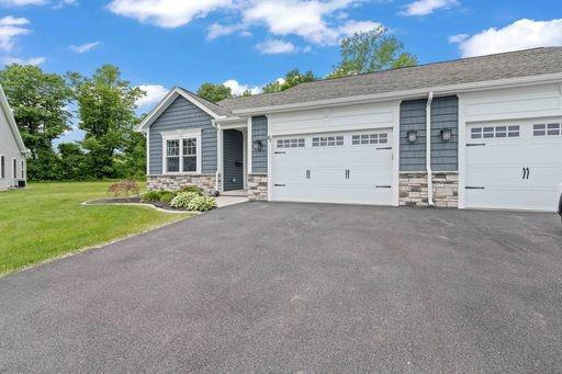 61 Kirkdale Cir, Greece, NY 14612 - ranch-style house featuring stone siding, driveway, a garage, and a front yard