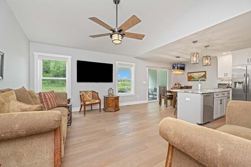 61 Kirkdale Cir, Greece, NY 14612 - living area featuring light wood finished floors and a ceiling fan