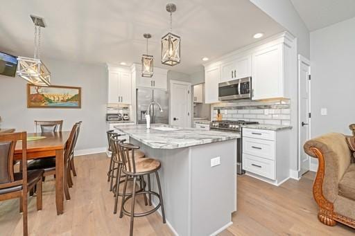 61 Kirkdale Cir, Greece, NY 14612 - kitchen featuring appliances with stainless steel finishes, white cabinetry, light wood finished floors, and recessed lighting