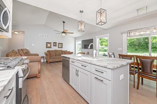 61 Kirkdale Cir, Greece, NY 14612 - kitchen with appliances with stainless steel finishes, healthy amount of natural light, light wood finished floors, vaulted ceiling, and ceiling fan