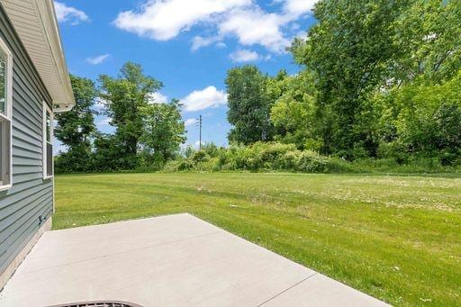 61 Kirkdale Cir, Greece, NY 14612 - view of grassy yard featuring a patio