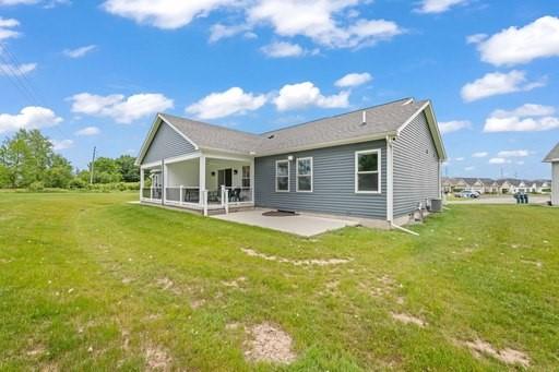 61 Kirkdale Cir, Greece, NY 14612 - back of house featuring a patio and a lawn
