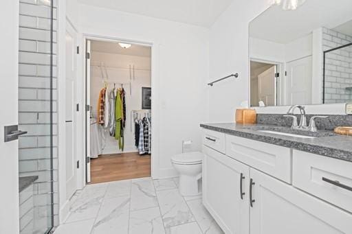 61 Kirkdale Cir, Greece, NY 14612 - bathroom featuring marble look tiles, vanity, a stall shower, and a walk in closet