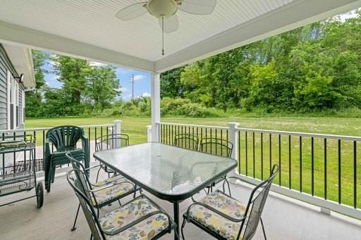 61 Kirkdale Cir, Greece, NY 14612 - view of patio / terrace featuring a ceiling fan, outdoor dining area, and view of scattered trees