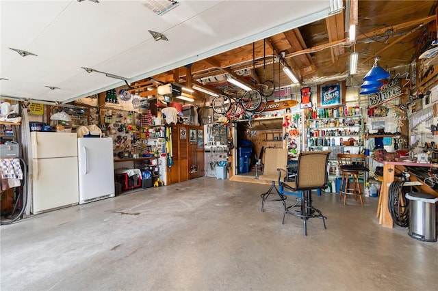 8545 Greig St, Sodus, NY 14555 - garage featuring a workshop area and freestanding refrigerator
