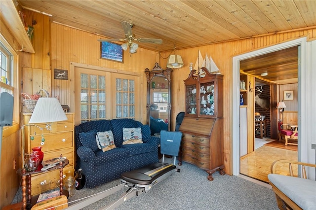 8545 Greig St, Sodus, NY 14555 - living area with wooden walls, ceiling fan, carpet flooring, wood ceiling, and french doors