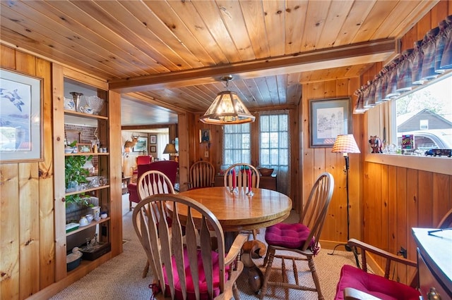 8545 Greig St, Sodus, NY 14555 - dining area featuring wood walls, carpet flooring, and a wood ceiling with exposed beams