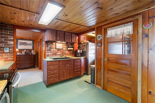 8545 Greig St, Sodus, NY 14555 - kitchen with appliances with stainless steel finishes, light carpet, wood ceiling, light countertops, and wooden walls
