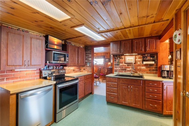 8545 Greig St, Sodus, NY 14555 - kitchen with appliances with stainless steel finishes, wood ceiling, light countertops, brown cabinets, and brick wall
