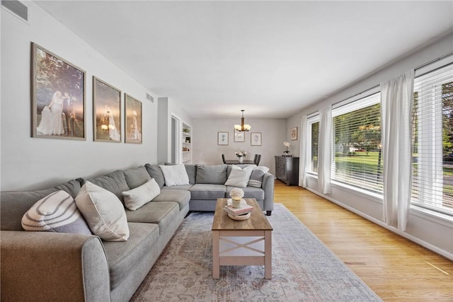 16 Trowbridge Trl, Pittsford, NY 14534 - living area featuring a chandelier, light wood-style flooring, and healthy amount of natural light