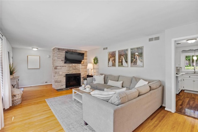 16 Trowbridge Trl, Pittsford, NY 14534 - living room with light wood finished floors and a stone fireplace