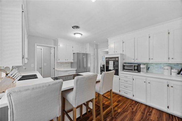 16 Trowbridge Trl, Pittsford, NY 14534 - kitchen featuring appliances with stainless steel finishes, decorative backsplash, white cabinets, and a peninsula