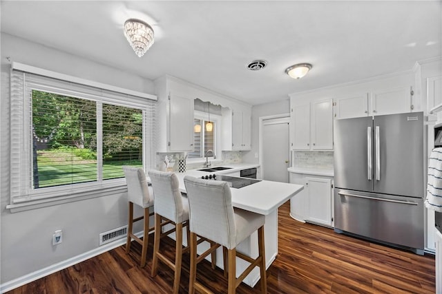 16 Trowbridge Trl, Pittsford, NY 14534 - kitchen featuring freestanding refrigerator, decorative backsplash, a peninsula, and white cabinetry