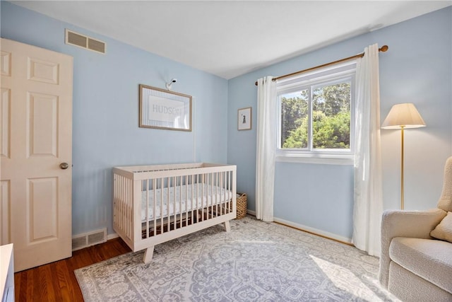 16 Trowbridge Trl, Pittsford, NY 14534 - bedroom featuring wood finished floors and a crib