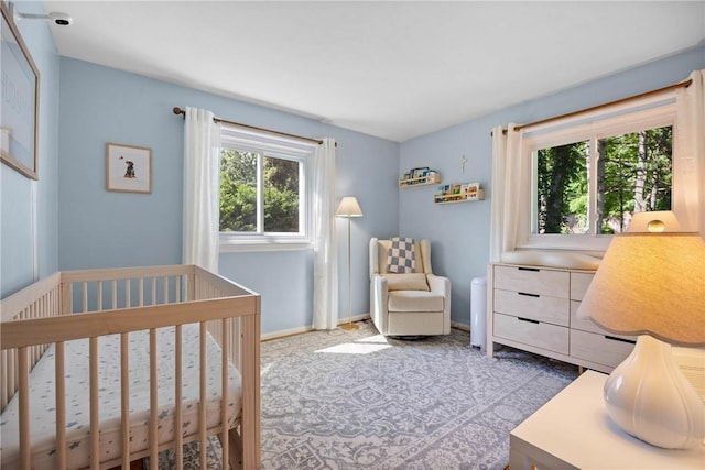 16 Trowbridge Trl, Pittsford, NY 14534 - carpeted bedroom with a nursery area and baseboards