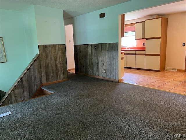 3980 Ridgelea Dr, Newfane, NY 14094 - empty room with a wainscoted wall, a textured ceiling, and light tile patterned floors