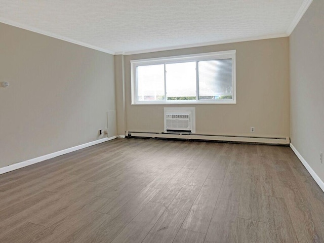 2432 E Ave Unit B, Brighton, NY 14610 - empty room with wood finished floors, baseboard heating, an AC wall unit, and ornamental molding