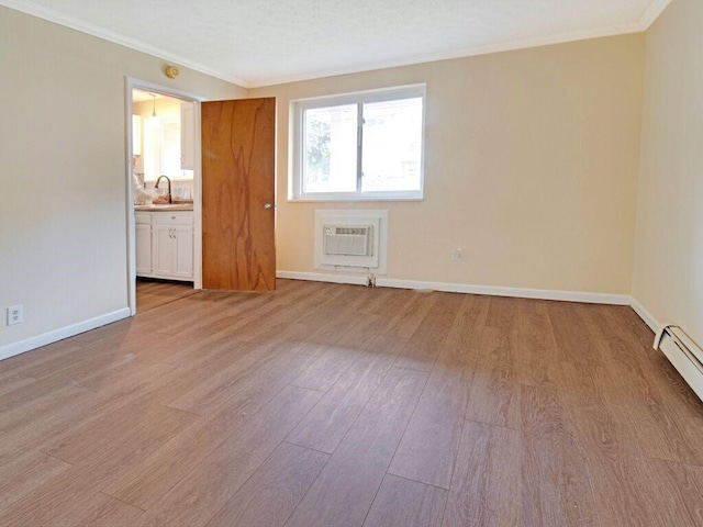 2432 E Ave Unit B, Brighton, NY 14610 - spare room with a wall unit AC, light wood-style flooring, crown molding, and a baseboard heating unit