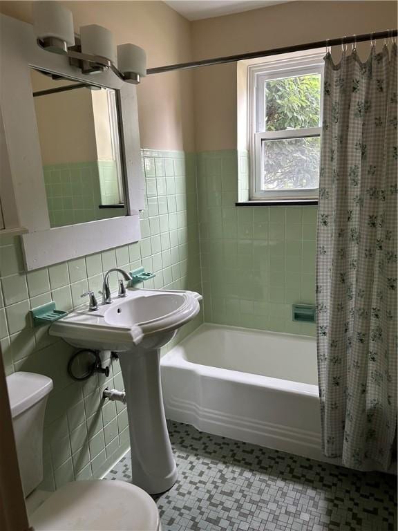 2432 E Ave Unit B, Brighton, NY 14610 - full bath with tile walls, shower / tub combo with curtain, tile patterned floors, and wainscoting