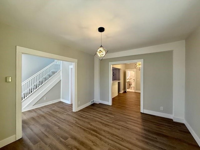 41 Garnet St, Rochester, NY 14609 - empty room with a chandelier, dark wood-style floors, and stairs