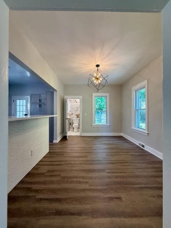 41 Garnet St, Rochester, NY 14609 - unfurnished living room featuring dark wood-style floors and a chandelier