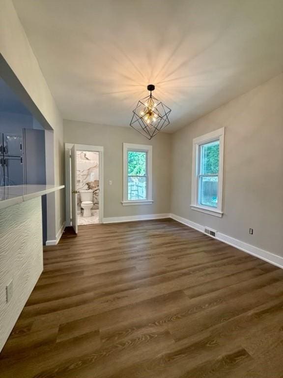 41 Garnet St, Rochester, NY 14609 - spare room featuring a chandelier and dark wood-style flooring